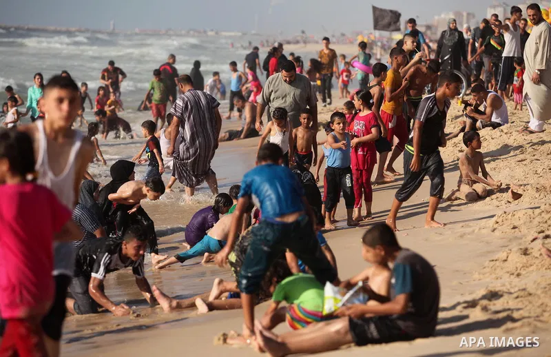 Palestinian children swim in the Mediterranean sea on the coast of Gaza city, on the third day of Eid al-Fitr holiday which marks the end of the Muslim holy month of Ramadan, on July 08, 2016. Photo by Ashraf Amra
