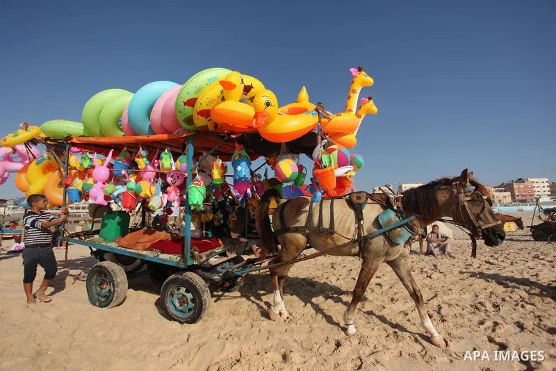 Palestinians enjoy a day at the beach of the Mediterranean sea on the coast of Gaza city, on the third day of Eid al-Fitr holiday which marks the end of the Muslim holy month of Ramadan, on July 08, 2016. Photo by Ashraf...