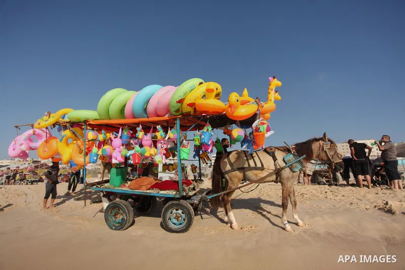 Palestinians enjoy a day at the beach of the Mediterranean sea on the coast of Gaza city, on the third day of Eid al-Fitr holiday which marks the end of the Muslim holy month of Ramadan, on July 08, 2016. Photo by Ashraf...