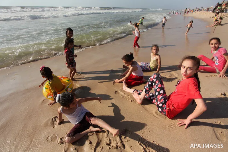 Palestinians enjoy a day at the beach of the Mediterranean sea on the coast of Gaza city, on the third day of Eid al-Fitr holiday which marks the end of the Muslim holy month of Ramadan, on July 08, 2016. Photo by Ashraf...