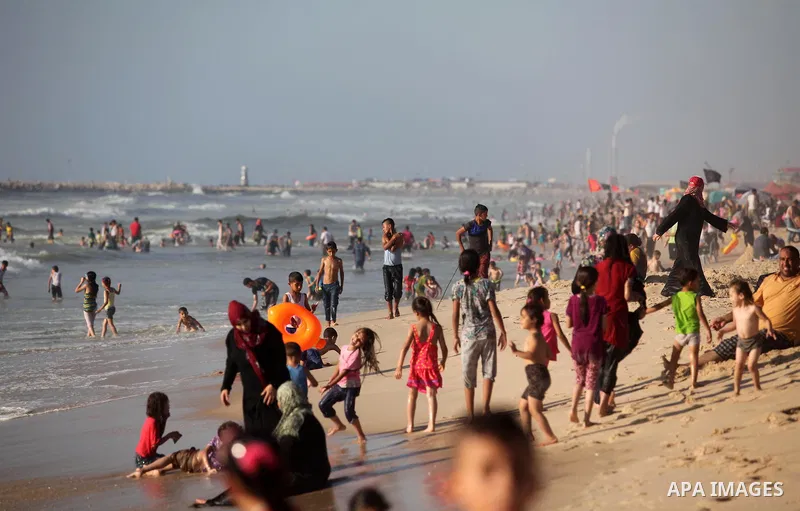 Palestinian children swim in the Mediterranean sea on the coast of Gaza city, on the third day of Eid al-Fitr holiday which marks the end of the Muslim holy month of Ramadan, on July 08, 2016. Photo by Ashraf Amra