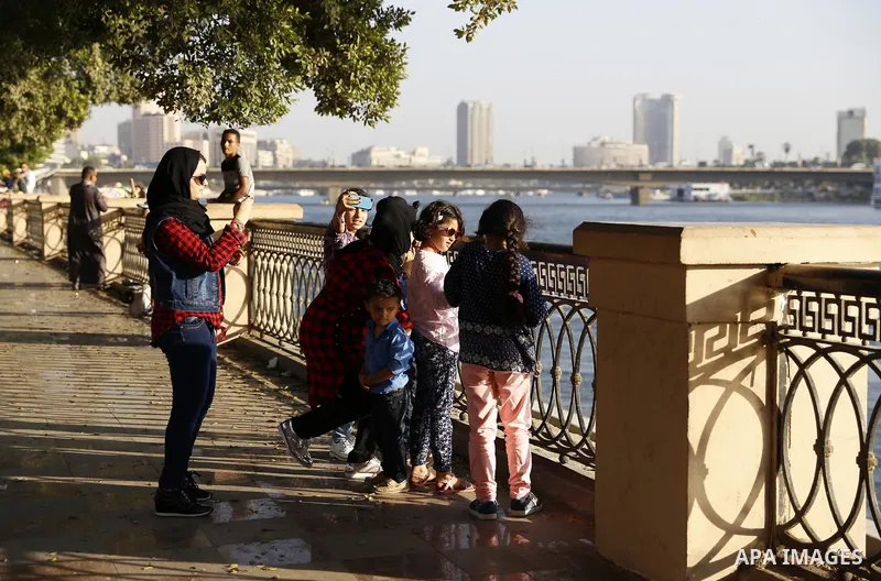 Egyptians walk past Nile River on the third day of Eid al-Fitr holiday which marks the end of the Muslim holy month of Ramadan, in Cairo, Egypt, on July 08, 2016. Photo by Amr Sayed