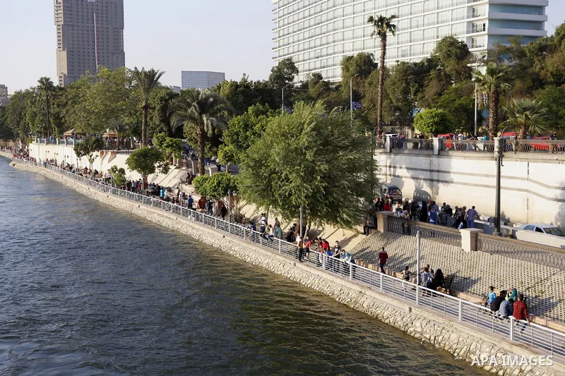 Egyptians walk past Nile River on the third day of Eid al-Fitr holiday which marks the end of the Muslim holy month of Ramadan, in Cairo, Egypt, on July 08, 2016. Photo by Amr Sayed