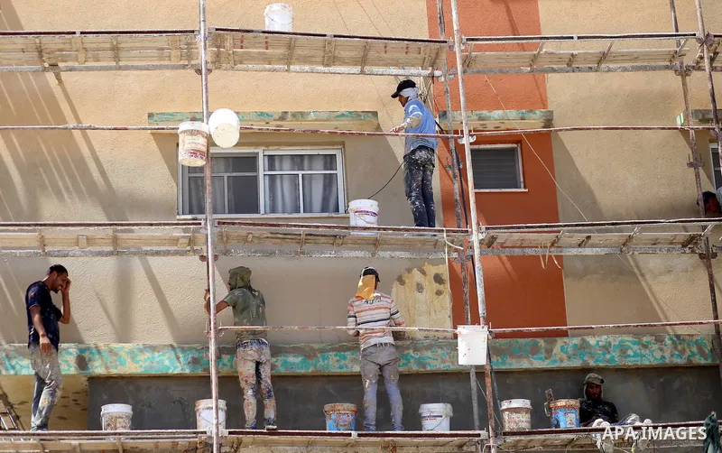 Palestinian construction workers work at the house, to marking the second anniversary of the 50-day Israeli war on Gaza Strip last summer, in Shejaiya neighborhood in Gaza city July 9, 2016. July 8th marks the two-year a...