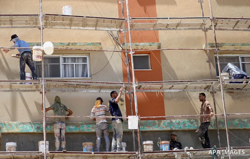Palestinian construction workers work at the house, to marking the second anniversary of the 50-day Israeli war on Gaza Strip last summer, in Shejaiya neighborhood in Gaza city July 9, 2016. July 8th marks the two-year a...