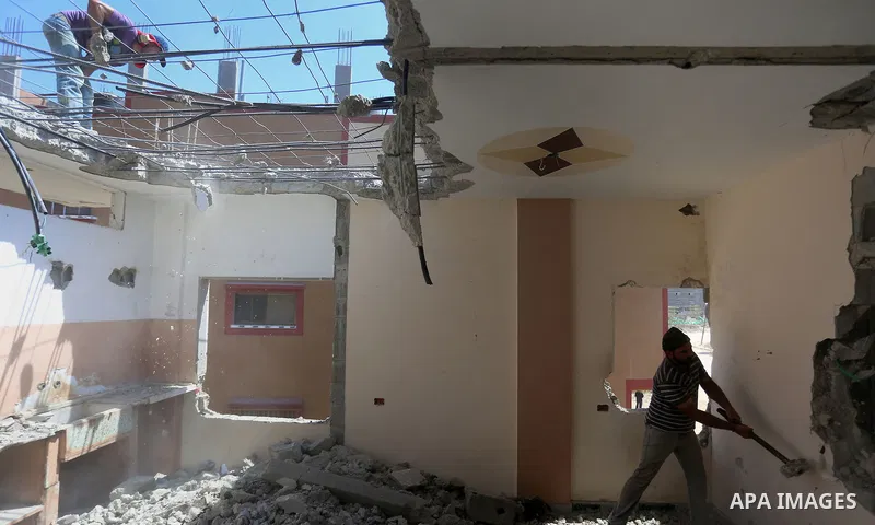 Palestinian construction workers work at the house, to marking the second anniversary of the 50-day Israeli war on Gaza Strip last summer, in Shejaiya neighborhood in Gaza city July 9, 2016. July 8th marks the two-year a...