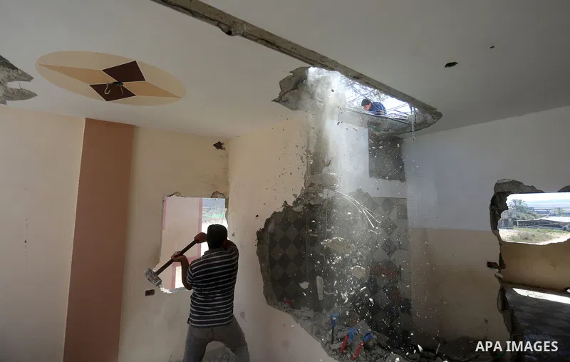 Palestinian construction workers work at the house, to marking the second anniversary of the 50-day Israeli war on Gaza Strip last summer, in Shejaiya neighborhood in Gaza city July 9, 2016. July 8th marks the two-year a...