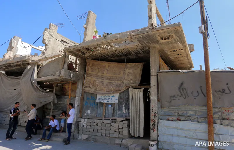 Palestinian construction workers work at the house, to marking the second anniversary of the 50-day Israeli war on Gaza Strip last summer, in Shejaiya neighborhood in Gaza city July 9, 2016. July 8th marks the two-year a...