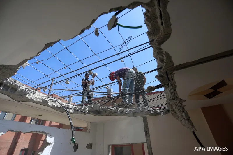 Palestinian construction workers work at the house, to marking the second anniversary of the 50-day Israeli war on Gaza Strip last summer, in Shejaiya neighborhood in Gaza city July 9, 2016. July 8th marks the two-year a...