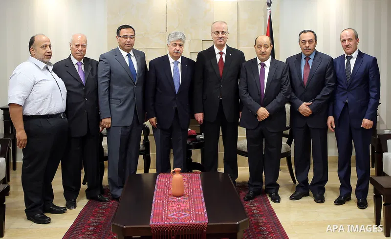 Palestinian Prime Minister, Rami Hamdallah, receives the Annual report of the Retirement Authority for 2015 in the West Bank city of Ramallah on July 11 , 2016. Photo by Prime Minister Office