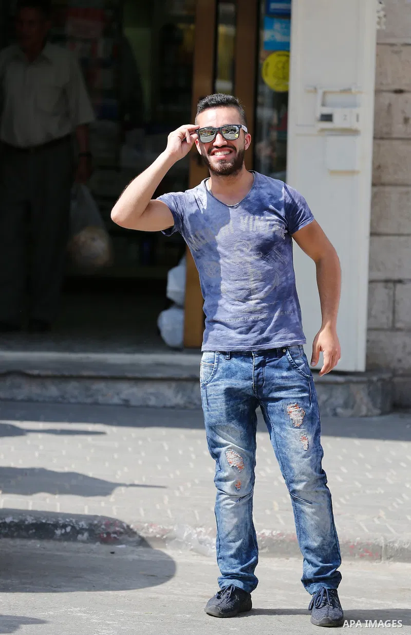 Palestinian high school students celebrate after heard their results of final exams known as "Tawjihi", in the West Bank city of Hebron on July 11, 2016. Photo by Wisam Hashlamoun