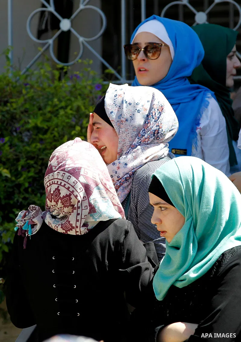 Palestinian high school students celebrate after heard their results of final exams known as "Tawjihi", in the West Bank city of Hebron on July 11, 2016. Photo by Wisam Hashlamoun