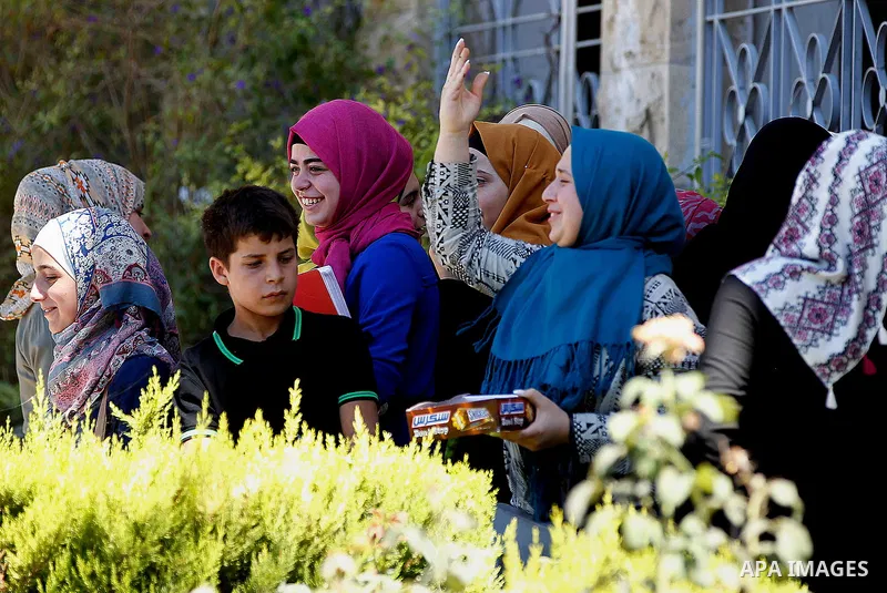 Palestinian high school students celebrate after heard their results of final exams known as "Tawjihi", in the West Bank city of Hebron on July 11, 2016. Photo by Wisam Hashlamoun