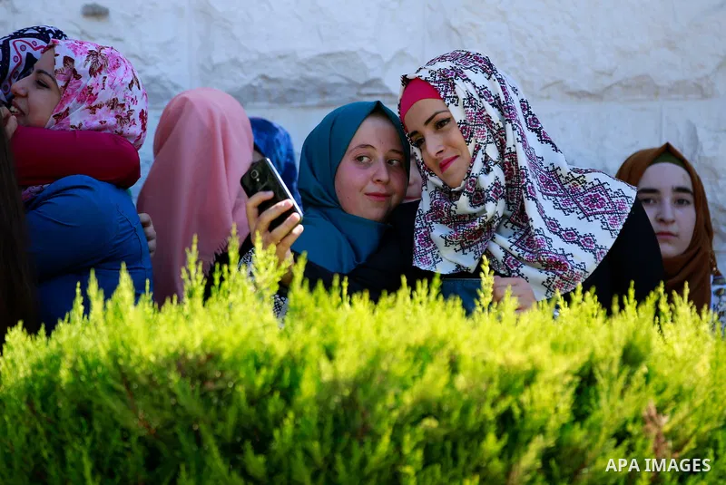 Palestinian high school students celebrate after heard their results of final exams known as "Tawjihi", in the West Bank city of Hebron on July 11, 2016. Photo by Wisam Hashlamoun