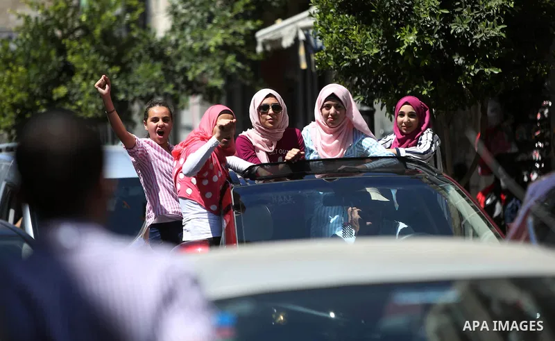 Palestinian high school students celebrate after heard their results of final exams known as "Tawjihi", in the West Bank city of Ramallah on July 11, 2016. Photo by Shadi Hatem