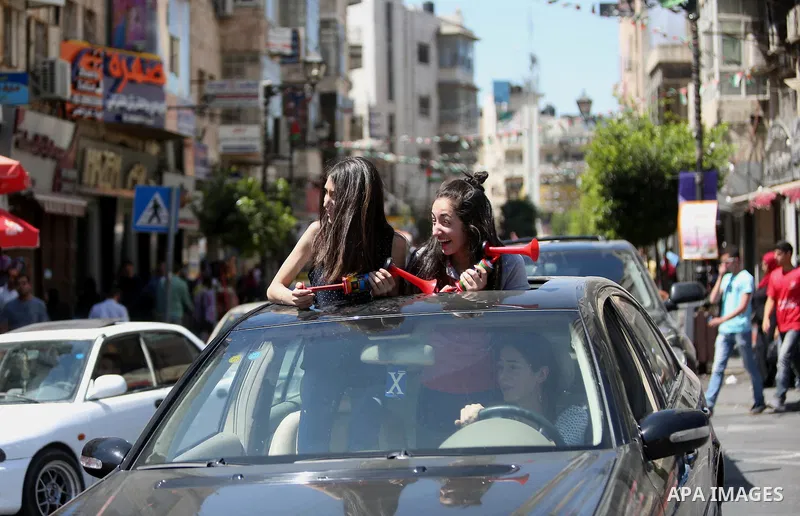Palestinian high school students celebrate after heard their results of final exams known as "Tawjihi", in the West Bank city of Ramallah on July 11, 2016. Photo by Shadi Hatem