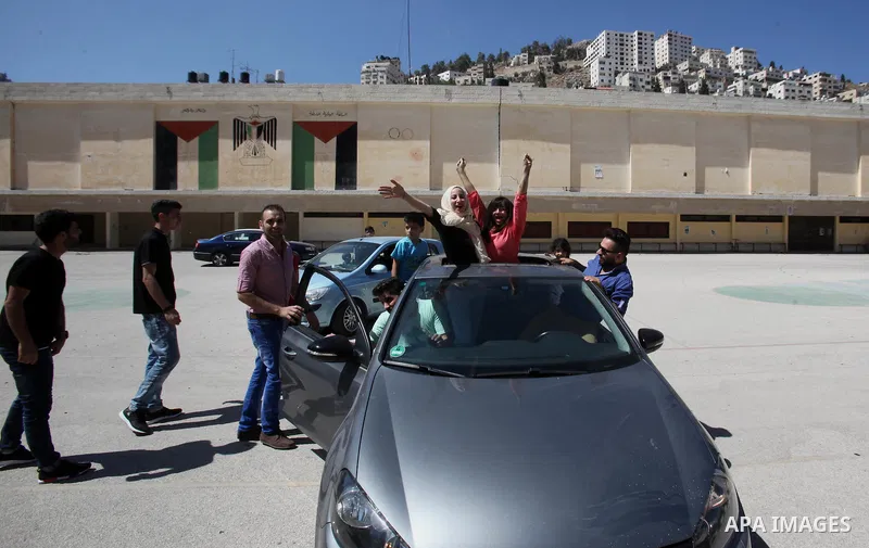 Palestinian high school students celebrate after heard their results of final exams known as "Tawjihi", in the West Bank city of Nablus on July 11, 2016. Photo by Nedal Eshtayah