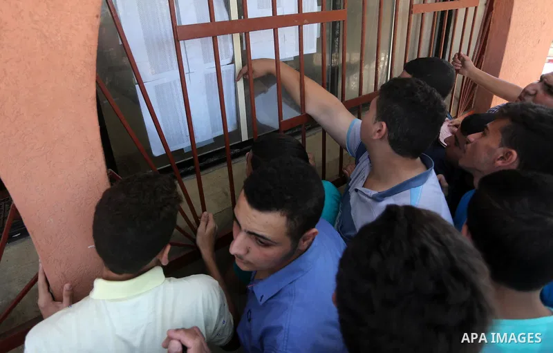Palestinian high school students look for their results of final high school exams, known as "Tawjihi" in Gaza city on July 11, 2016. Photo by Mohammed Asad