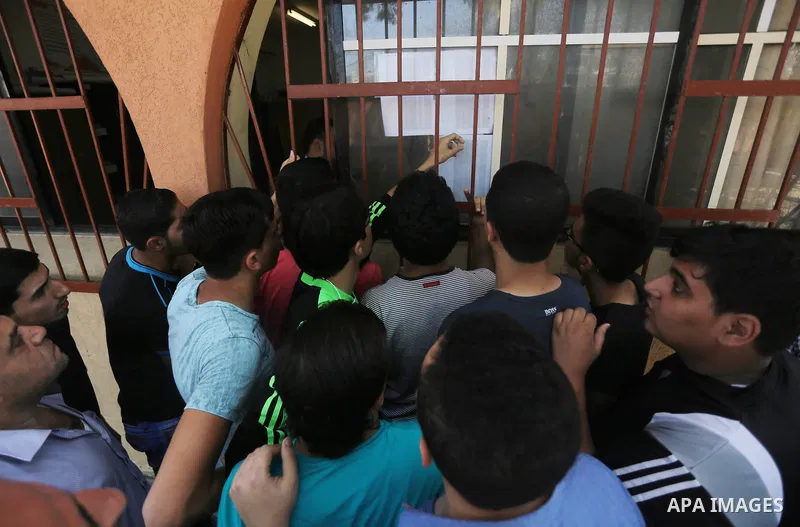 Palestinian high school students look for their results of final high school exams, known as "Tawjihi" in Gaza city on July 11, 2016. Photo by Mohammed Asad