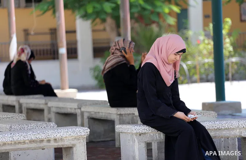 Palestinian high school students look for their results of final high school exams, known as "Tawjihi" in Gaza city on July 11, 2016. Photo by Mohammed Asad