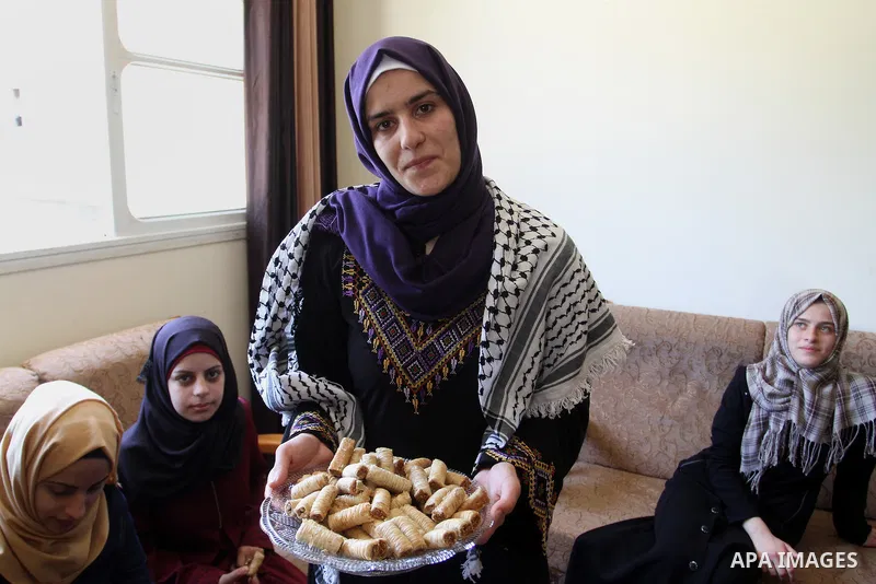 A Palestinian high school student, Sabrin Sheikh Ahmed 99.4, celebrates with her family after heard the results of her final exams known as ''Tawjihi'', in Khan Younis in the southern Gaza strip, on July 11, 2016. Photo...