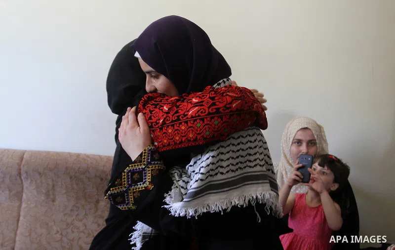 A Palestinian high school student, Sabrin Sheikh Ahmed 99.4, celebrates with her family after heard the results of her final exams known as ''Tawjihi'', in Khan Younis in the southern Gaza strip, on July 11, 2016. Photo...