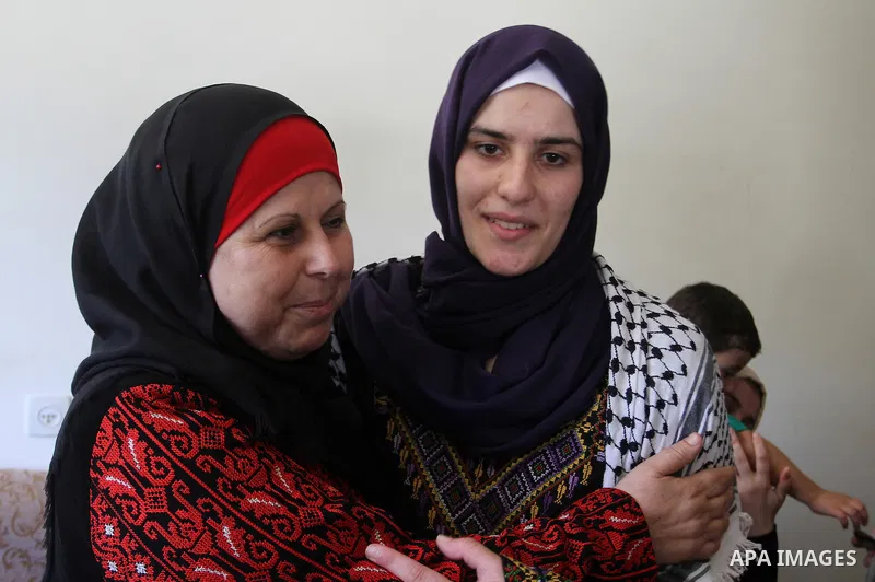 A Palestinian high school student, Sabrin Sheikh Ahmed 99.4, celebrates with her family after heard the results of her final exams known as ''Tawjihi'', in Khan Younis in the southern Gaza strip, on July 11, 2016. Photo...