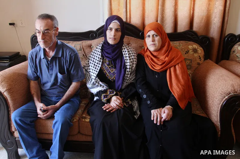 A Palestinian high school student, Sabrin Sheikh Ahmed 99.4, celebrates with her family after heard the results of her final exams known as ''Tawjihi'', in Khan Younis in the southern Gaza strip, on July 11, 2016. Photo...