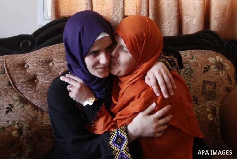 A Palestinian high school student, Sabrin Sheikh Ahmed 99.4, celebrates with her family after heard the results of her final exams known as ''Tawjihi'', in Khan Younis in the southern Gaza strip, on July 11, 2016. Photo...