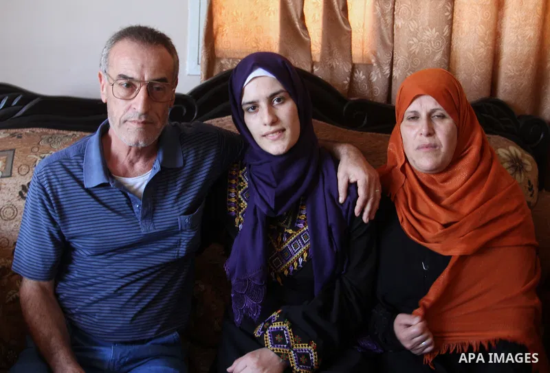 A Palestinian high school student, Sabrin Sheikh Ahmed 99.4, celebrates with her family after heard the results of her final exams known as ''Tawjihi'', in Khan Younis in the southern Gaza strip, on July 11, 2016. Photo...