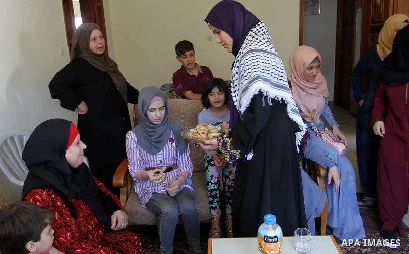A Palestinian high school student, Sabrin Sheikh Ahmed 99.4, celebrates with her family after heard the results of her final exams known as ''Tawjihi'', in Khan Younis in the southern Gaza strip, on July 11, 2016. Photo...
