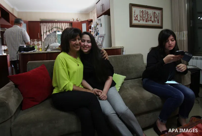 A Palestinian high school student, Yasmin Murad Suleiman 99.4, celebrates with her family after heard the results of her final exams known as ''Tawjihi'', in the West Bank city of Nablus, on July 11, 2016. Photo by Nedal...