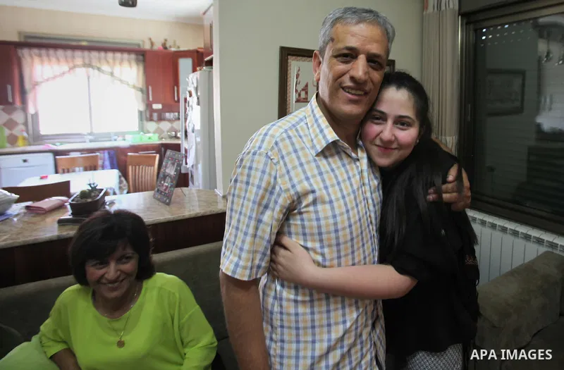 A Palestinian high school student, Yasmin Murad Suleiman 99.4, celebrates with her family after heard the results of her final exams known as ''Tawjihi'', in the West Bank city of Nablus, on July 11, 2016. Photo by Nedal...