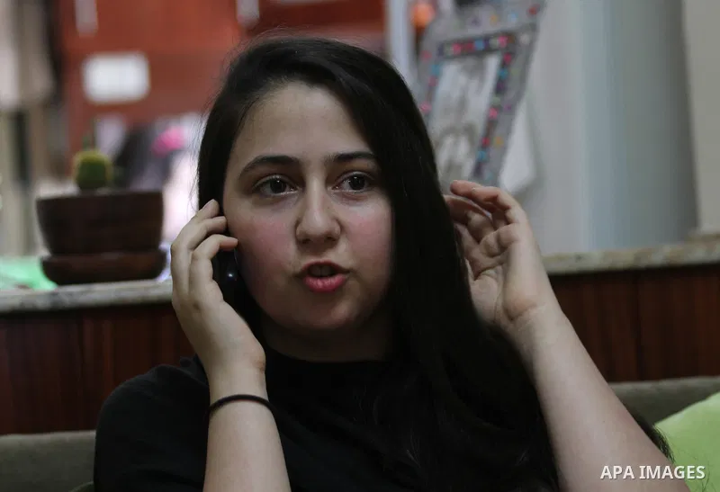 A Palestinian high school student, Yasmin Murad Suleiman 99.4, celebrates with her family after heard the results of her final exams known as ''Tawjihi'', in the West Bank city of Nablus, on July 11, 2016. Photo by Nedal...