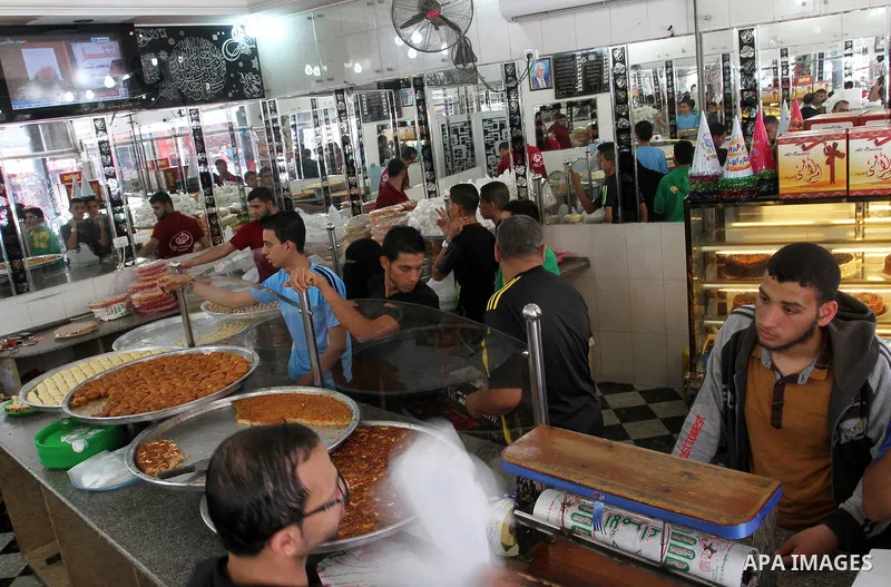 Palestinian vendors sell sweets after the results of high school exams, known as ''Tawjihi''', in Rafah in the southern Gaza strip, on July 11, 2016. Photo by Abed Rahim Khatib