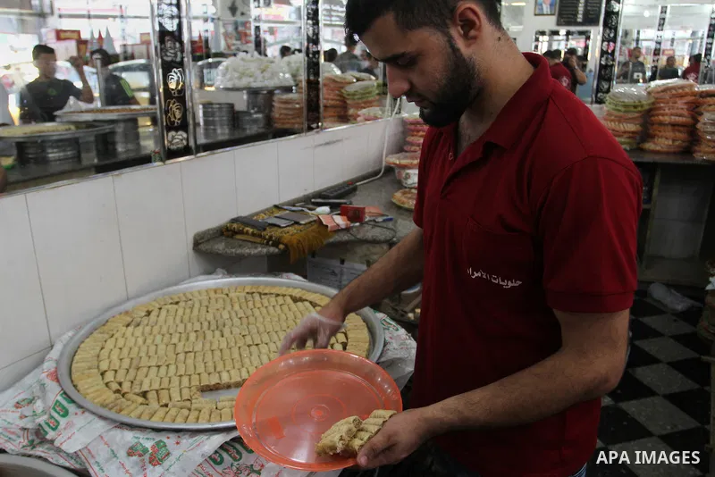 Palestinian vendors sell sweets after the results of high school exams, known as ''Tawjihi''', in Rafah in the southern Gaza strip, on July 11, 2016. Photo by Abed Rahim Khatib