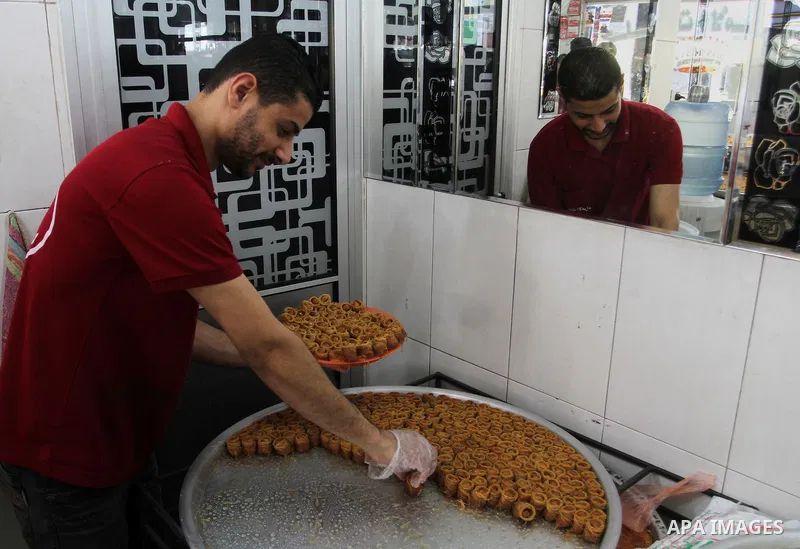 Palestinian vendors sell sweets after the results of high school exams, known as ''Tawjihi''', in Rafah in the southern Gaza strip, on July 11, 2016. Photo by Abed Rahim Khatib