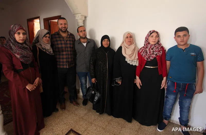 A Palestinian high school student, Mai Kamal al-Bawab 99.2, celebrates with her family after heard the results of her final exams known as ''Tawjihi'', in the Gaza city, on July 11, 2016. Photo by Ashraf Amra