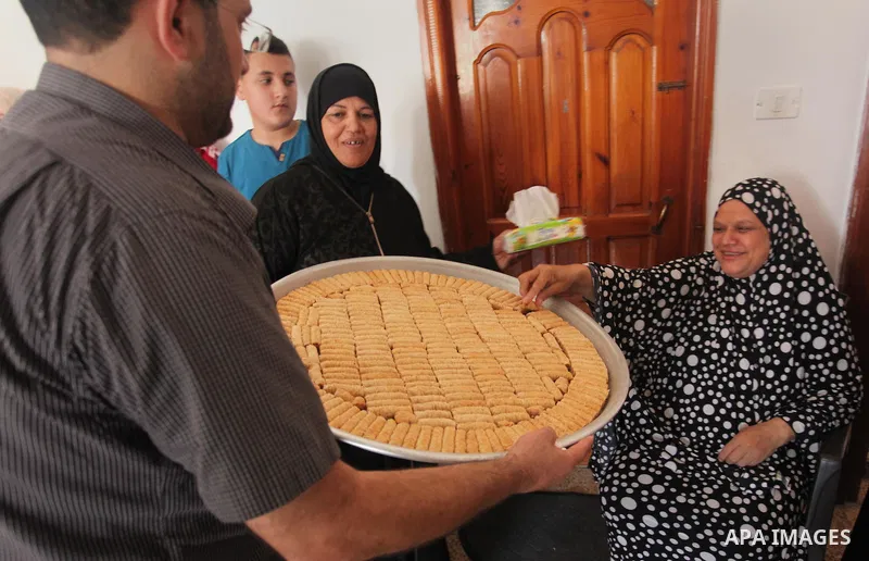 A Palestinian high school student, Mai Kamal al-Bawab 99.2, celebrates with her family after heard the results of her final exams known as ''Tawjihi'', in the Gaza city, on July 11, 2016. Photo by Ashraf Amra