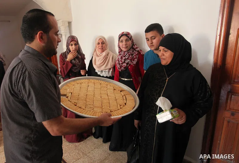 A Palestinian high school student, Mai Kamal al-Bawab 99.2, celebrates with her family after heard the results of her final exams known as ''Tawjihi'', in the Gaza city, on July 11, 2016. Photo by Ashraf Amra