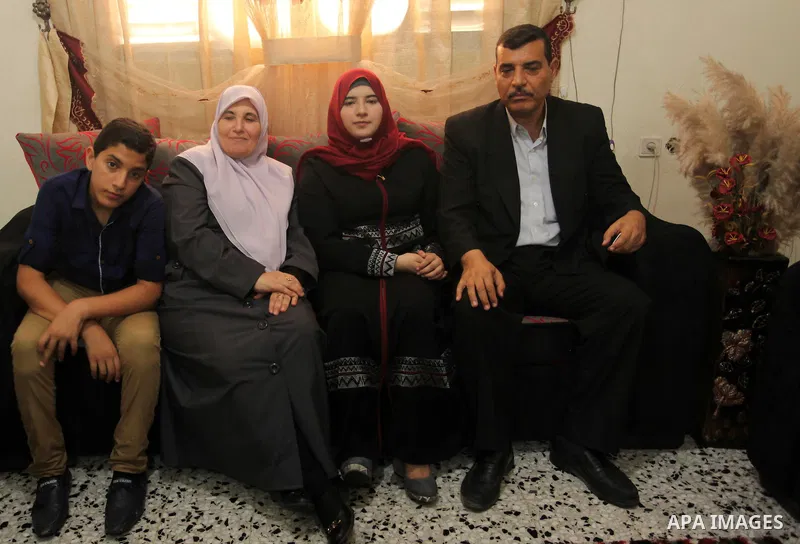 A Palestinian high school student,Amani Mohammed Shatat 99.6, celebrates with her family after heard the results of her final exams known as ''Tawjihi'', in the Gaza city, on July 11, 2016. Photo by Ashraf Amra