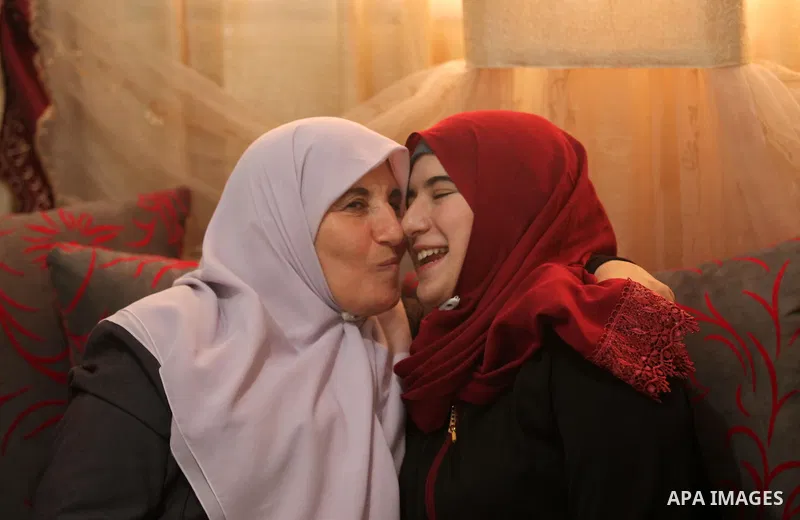A Palestinian high school student,Amani Mohammed Shatat 99.6, celebrates with her family after heard the results of her final exams known as ''Tawjihi'', in the Gaza city, on July 11, 2016. Photo by Ashraf Amra