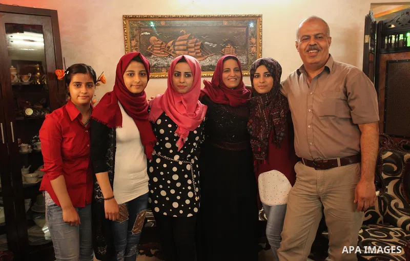 A Palestinian high school student, Aseel Marwan Shatila 99.1, celebrates with her family after heard the results of her final exams known as ''Tawjihi'', in the Gaza city, on July 11, 2016. Photo by Ashraf Amra