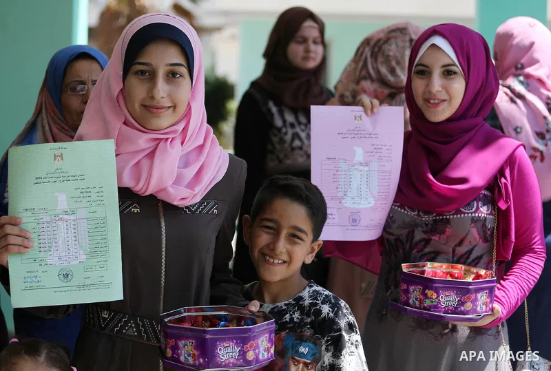 Palestinian high school students celebrate after heard their results of final exams known as "Tawjihi" in Gaza city on July 12, 2016. Photo by Mohammed Asad