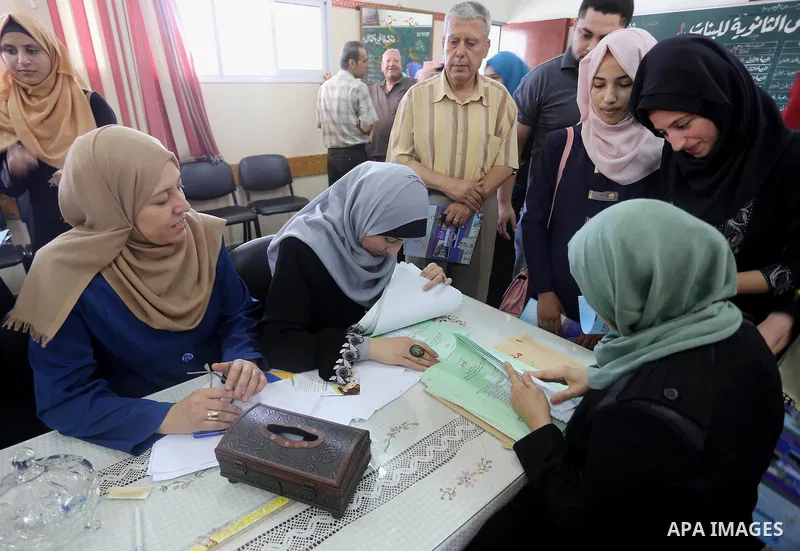 Palestinian high school students look for their results of final high school exams, known as "Tawjihi" in Gaza city on July 12, 2016. Photo by Mohammed Asad