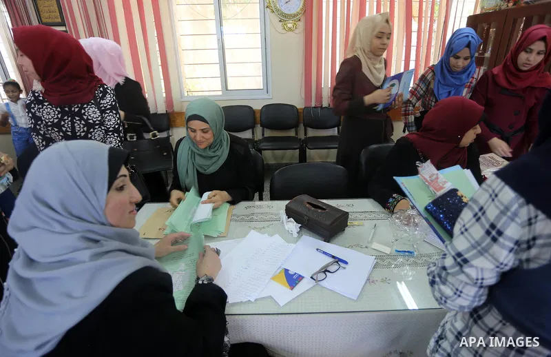 Palestinian high school students look for their results of final high school exams, known as "Tawjihi" in Gaza city on July 12, 2016. Photo by Mohammed Asad