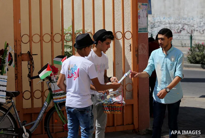 Palestinian high school students celebrate after heard their results of final exams known as "Tawjihi" in Gaza city on July 12, 2016. Photo by Mohammed Asad