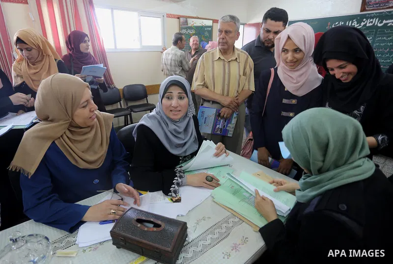 Palestinian high school students look for their results of final high school exams, known as "Tawjihi" in Gaza city on July 12, 2016. Photo by Mohammed Asad