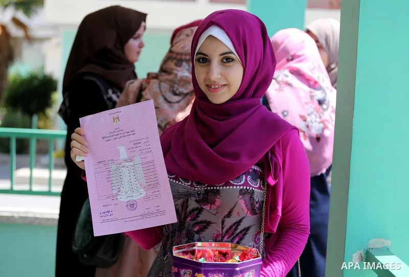 Palestinian high school students celebrate after heard their results of final exams known as "Tawjihi" in Gaza city on July 12, 2016. Photo by Mohammed Asad