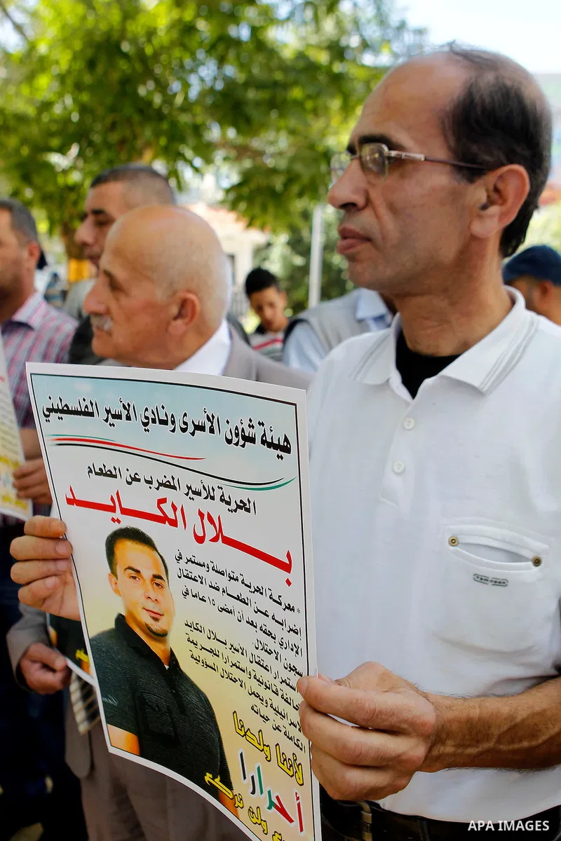 Palestinians take part in a demonstration calling for the release of Bilal Kayed a Palestinian prisoner on hunger strike, in the West bank city of Hebron on July 12, 2016. Photo by Wisam Hashlamoun